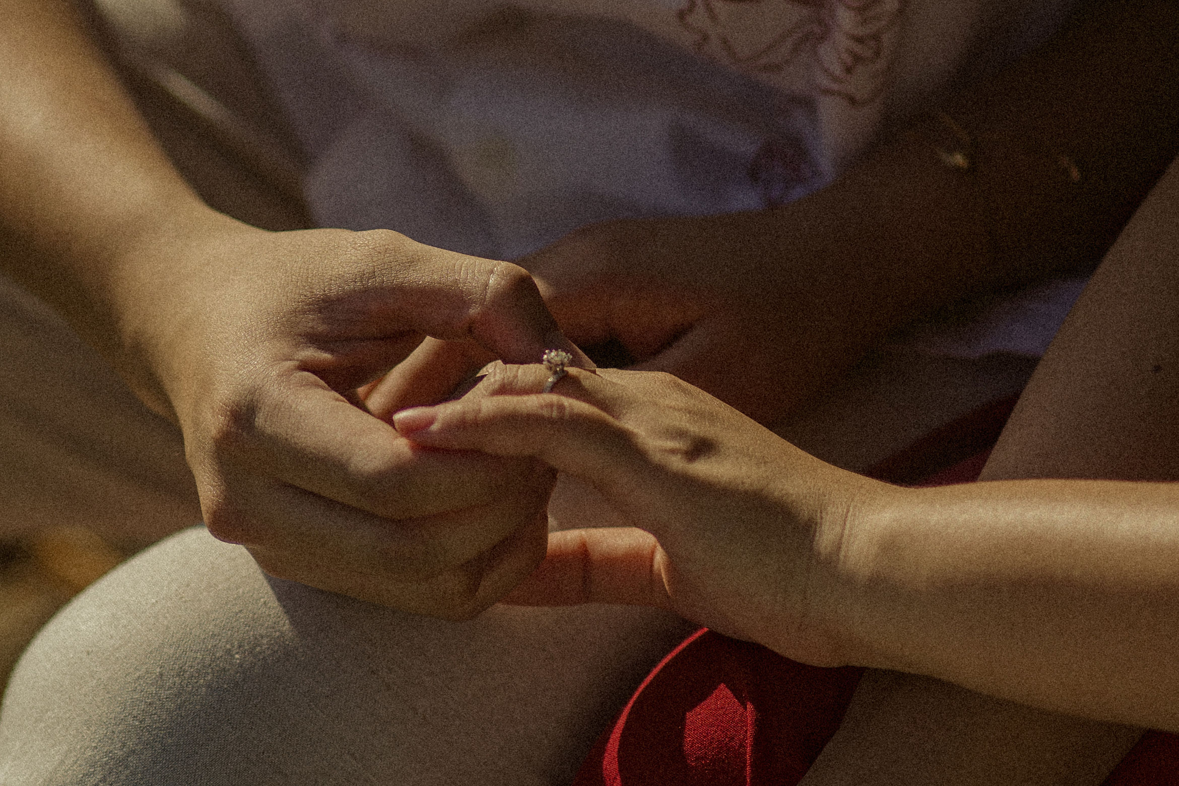 The engagement ring being placed on her finger