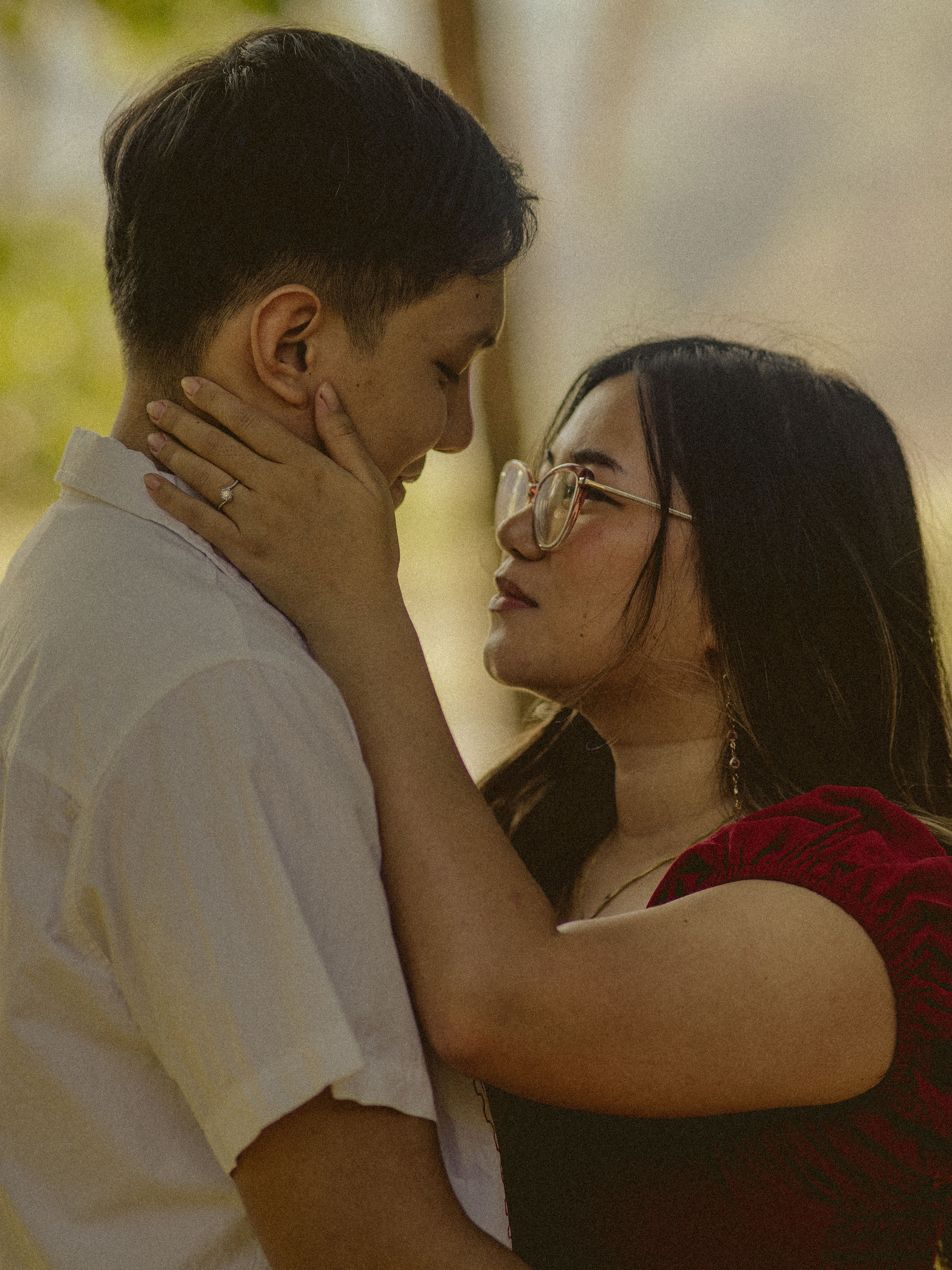 Alexandra and Jerome sharing a tender moment, her ring hand resting on his face